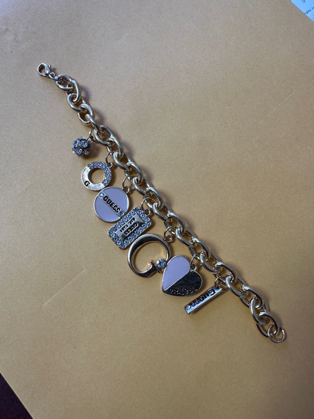 Guess Gold-Tone Charm Bracelet with Light Pink Accents
